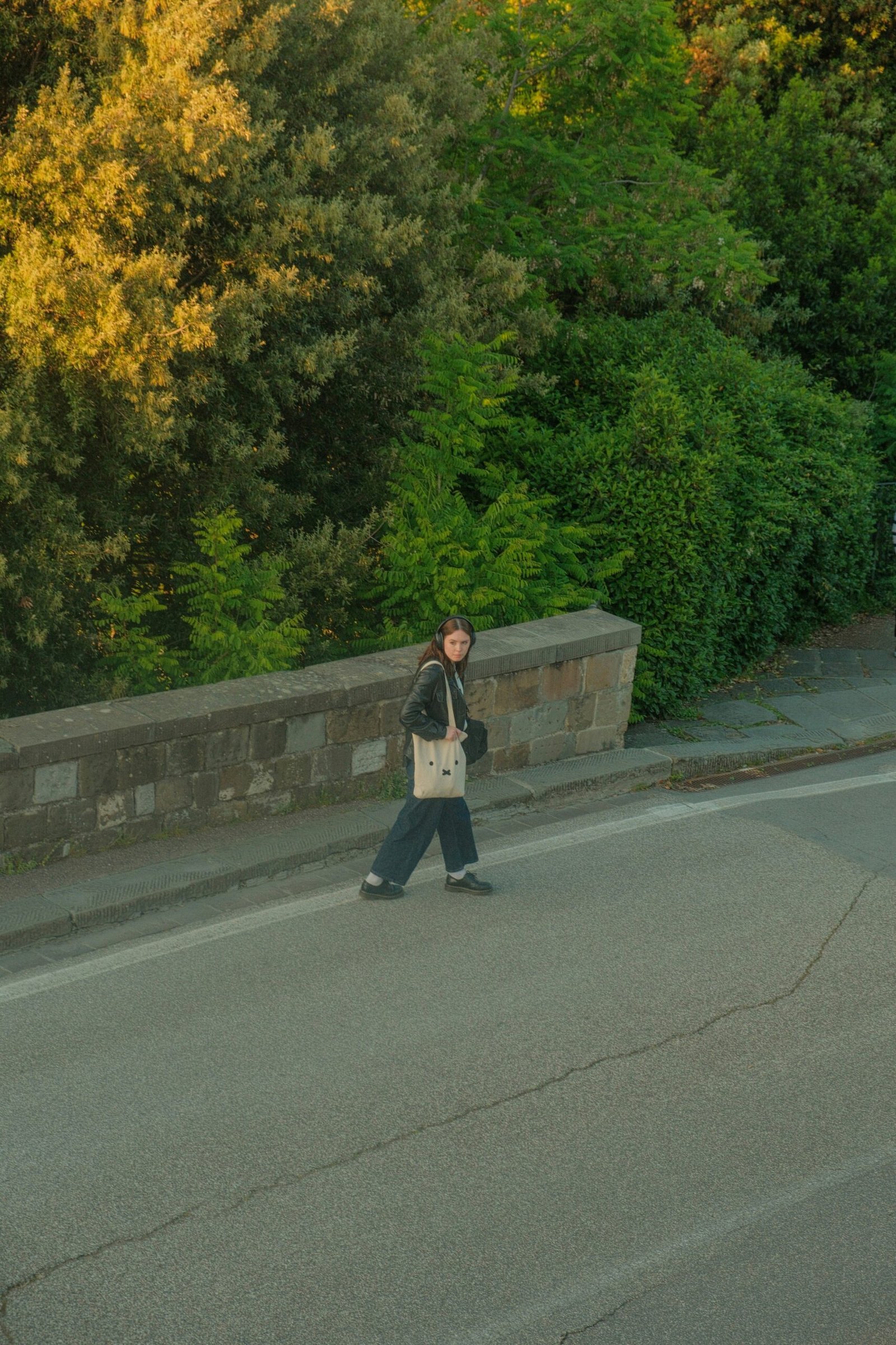 a person walking down the street with a bag