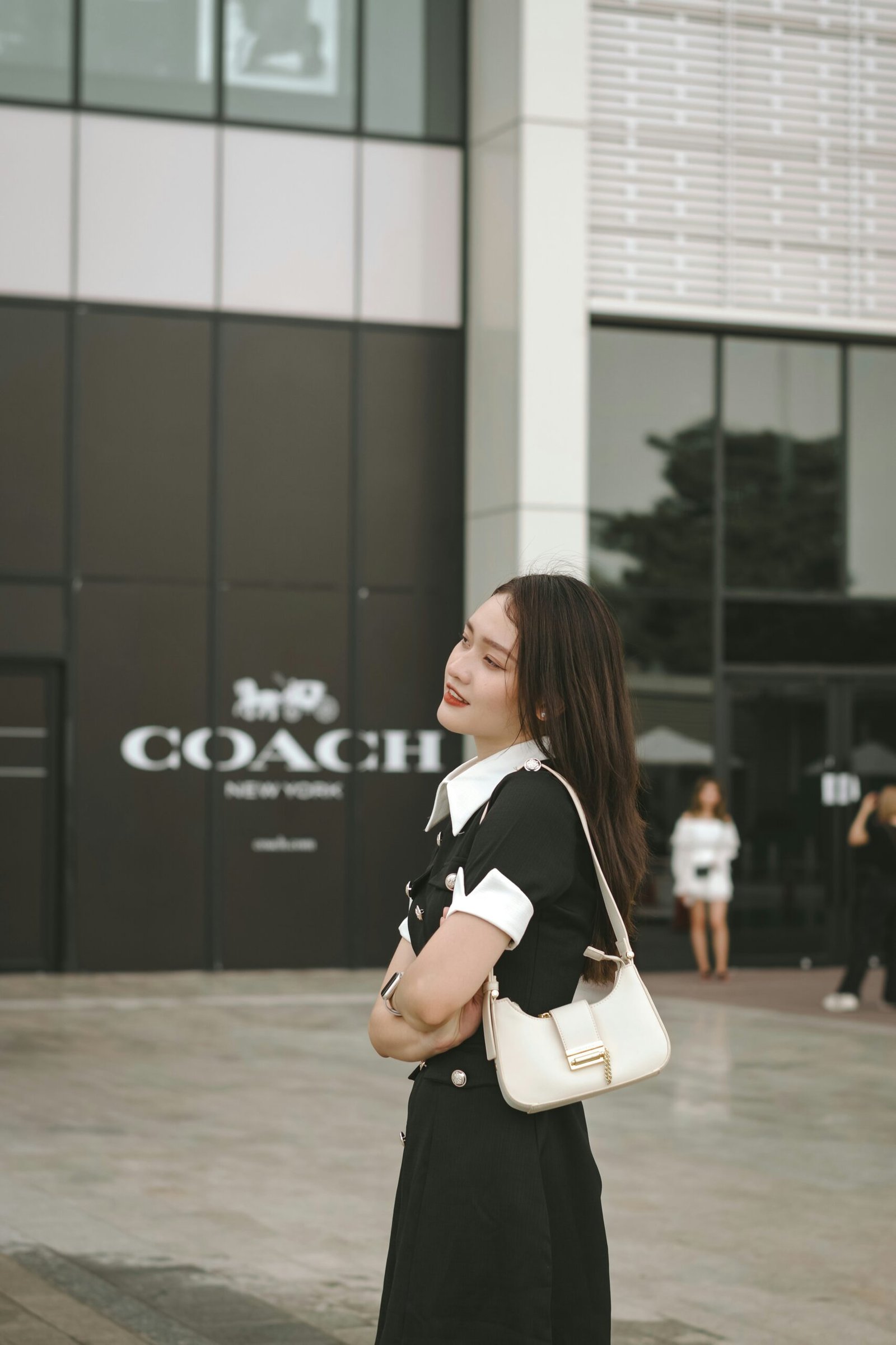 a woman standing in front of a building